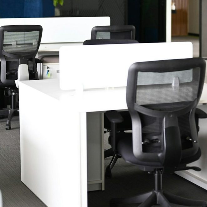 Office Relocation and Installation Office movers moving a sofa in plastic for protection during an office relocation.