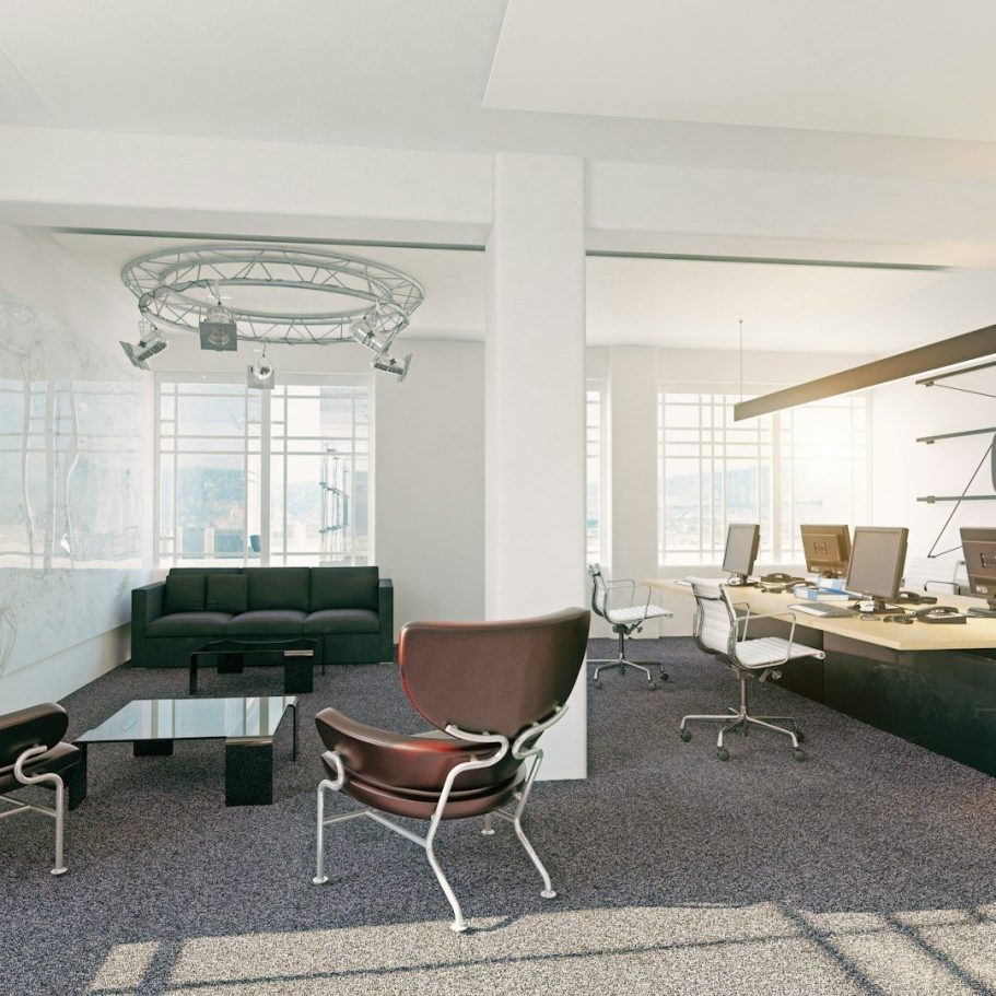 Interior Office Design Services Office interior design with a lounge area and commercial office desk setups.